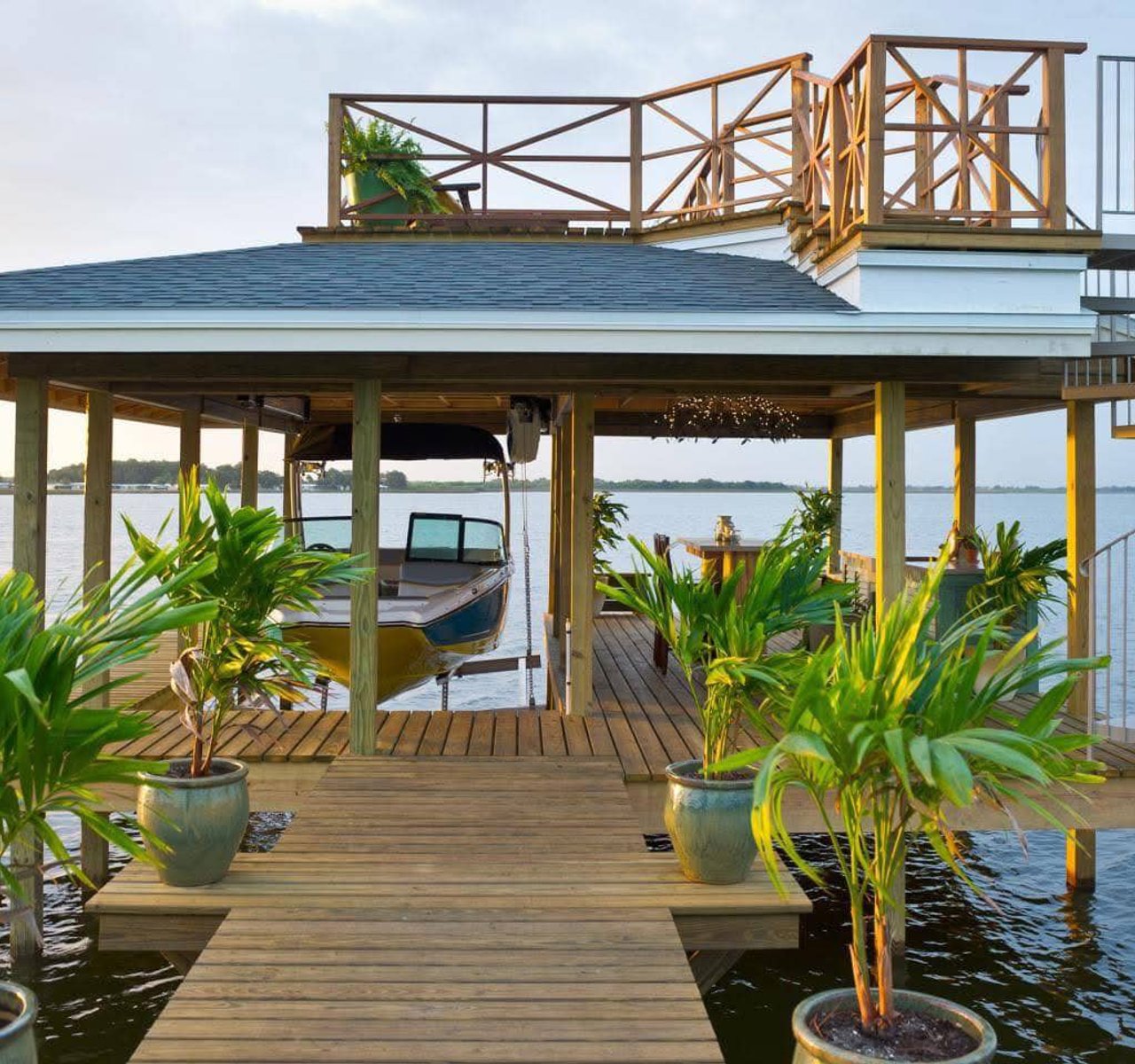 Custom covered boat dock with an upper deck